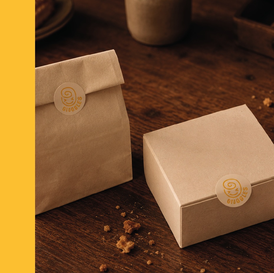 Giggles bakery packaging on a warm wooden counter